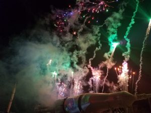 Pyrotechnics light up the night sky above the Saturn 1B rocket as the Holidays in Space show comes to a close.