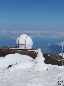 A Weatherboy team meteorologist makes a snowman on Hawaii's Big Island near the summit of Mauna Kea. Photo: Weatherboy