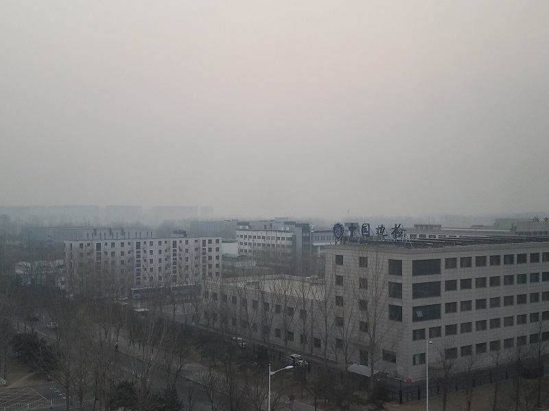 Acrid haze floats above the surface, enveloping buildings with a toxic cloud of pollutants. Photo: Weatherboy