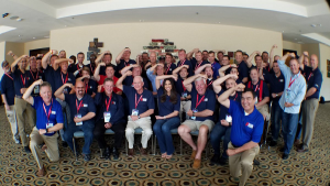 Guests of a past National Tropical Weather Conference event pose for a photograph, giving the "Hurricane Strong" pose. #HurricaneStrong is a part of a hurricane season preparedness campaign created by the FLASH Alliance.