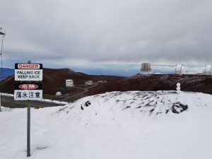 A snowman sits on top of a hill near the summit of Hawaii's Mauna Kea, surrounded by telescopes that dot the high altitude landscape. Photograph: Weatherboy