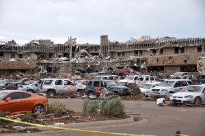 The storm-ravaged Moore Medical Center, part of the Norman Regional Health System, stands in Moore, Okla., May 21, 2013, a day after an EF5 tornado with winds exceeding 200 miles per hour tore through the Oklahoma city suburb. U.S. Service members assisted in disaster response efforts in the aftermath of the tornado, which killed 24 people, injured more than 200 and displaced thousands. Though the medical center was virtually destroyed, personnel reported no casualties. Cars nearby were marked with orange paint to indicate rescue workers had checked them for victims and cleared them. Image: U.S. Department of Defense
